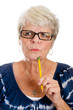 Photo: Elderly woman thinking hard with a pencil Elderly woman thinking hard with a pencil