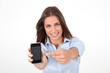 Portrait of beautiful young woman holding smartphone