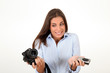 Young woman comparing digital compact and reflex cameras