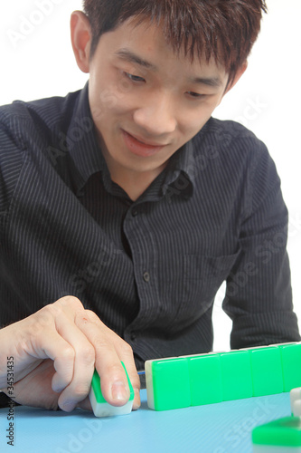 Photo: Chinese man play Mahjong, traditional China gamble. Chinese man play Mahjong, traditional China gamble.