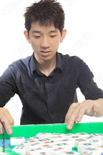 Photo: Chinese man play Mahjong, traditional China gamble. Chinese man play Mahjong, traditional China gamble.