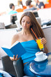 woman reading book in coffee shop woman reading book in coffee shop
