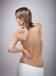 Woman massaging pain back isolated on white Woman massaging pain back isolated on white