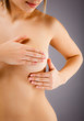 Woman examining her breast