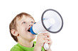 Little boy in green t-shirt shouts something into megaphone