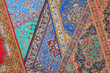 Seven varicoloured carpets lie in random order on each other