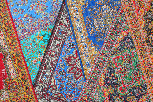 Photo: Seven varicoloured carpets lie in random order on each other Seven varicoloured carpets lie in random order on each other
