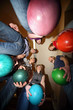 Friends stand in circle and everybody hold ball for bowling