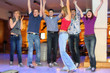 Friends rejoice for successful throw of ball of bowling