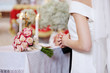 Bride and a bridal bouquet during the wedding ceremony Bride and a bridal bouquet during the wedding ceremony