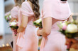 Row of bridesmaids with bouquets at wedding ceremony
