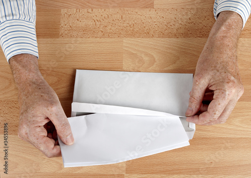 Photo: Man mailing letter in white envelope Man mailing letter in white envelope