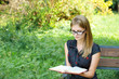 young fair-haired woman reading book