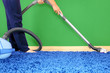 Vacuum cleaner in action-men cleaner a carpet.