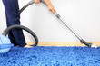 Vacuum cleaner in action-men cleaner a carpet.