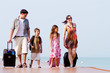 A young and attractive family with their luggages.