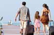A young and attractive family with their luggages.