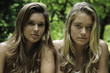 portrait of two sisters outdoors in a hawaii forest