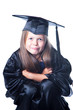 Cute girl in graduation dress on isolated white