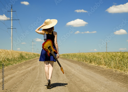 Photo: Rock girl with guitar at countryside. Rock girl with guitar at countryside.