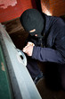 robber and the thief in a mask hijacks the car