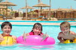 Happy children playing in pool
