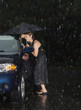 Woman locked out of her car in the rain