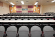 Empty hall for presentation with grey armchairs Empty hall for presentation with grey armchairs