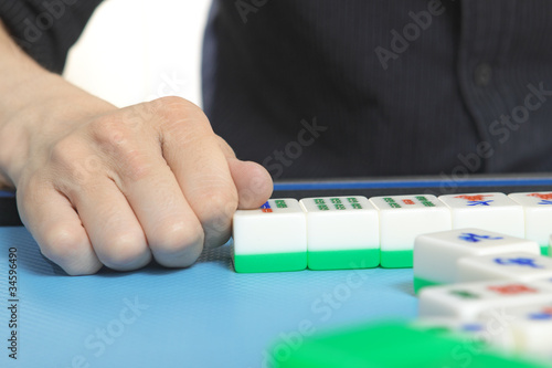 Photo: Chinese man play Mahjong, traditional China gamble. Chinese man play Mahjong, traditional China gamble.