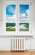 White plastic window with radiator under.View through glass White plastic window with radiator under.View through glass