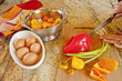 Chopping peppers and onions to cook with eggs