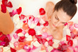 Photo: Attractive naked girl enjoys a bath with milk and rose petals Attractive naked girl enjoys a bath with milk and rose petals