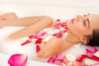 Photo: Attractive naked girl enjoys a bath with milk and rose petals Attractive naked girl enjoys a bath with milk and rose petals