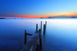 Sunset at dusk along a wooden pier, high saturation image. Sunset at dusk along a wooden pier, high saturation image.