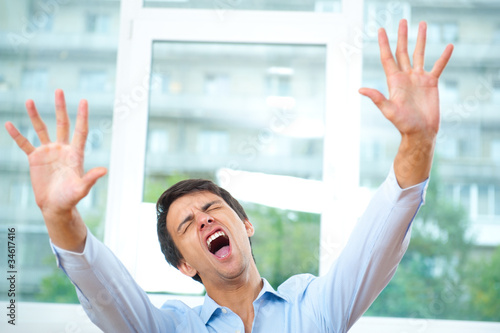 Photo: Portrait of young teacher screaming in empty classroom Portrait of young teacher screaming in empty classroom