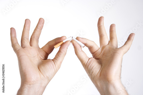 Photo: Man's hands breaking a cigarette Man's hands breaking a cigarette