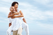 Young couple enjoying a piggy back ride