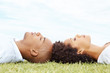 Sweet young couple lying on grass sleeping