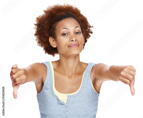 Photo: Upset young woman showing thumbs down Upset young woman showing thumbs down