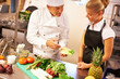 Chef giving culinary lessons to trainee