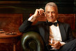 Man enjoying cigar and brandy