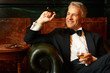Relaxed man enjoying cigar and brandy
