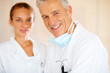 Smiling male researcher with his assistant in background