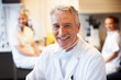 Happy scientist with colleagues in background at the lab