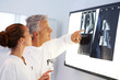 Two Doctors examining a x-ray at hospital