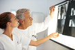 Serious medical colleagues examining an X-ray