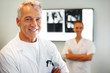 Portrait of smiling male doctor in clinic