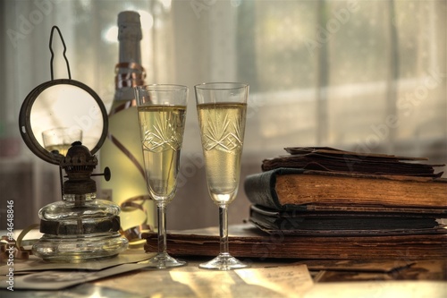 Photo: Champagne and old books and letters. Champagne and old books and letters.