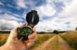 man holding compass in field