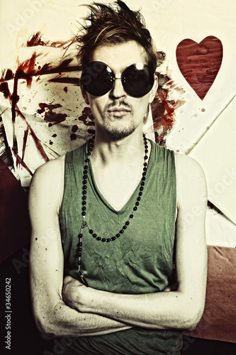 Photo: Portrait of young punk in round sunglasses Portrait of young punk in round sunglasses